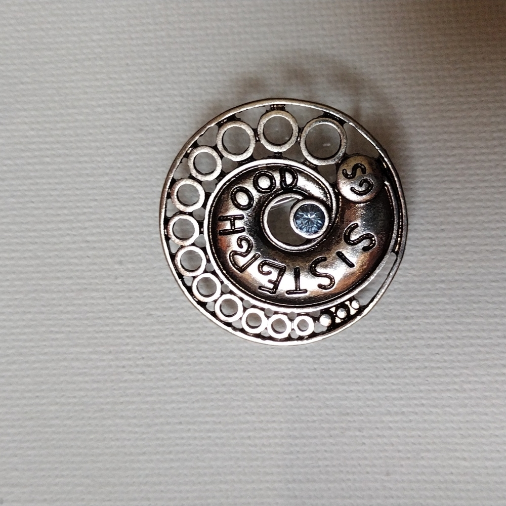 Sisterhood brooch.